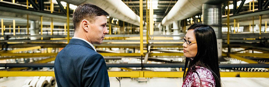 attorney with his client in a factory