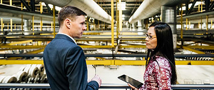 attorney with his client in a factory