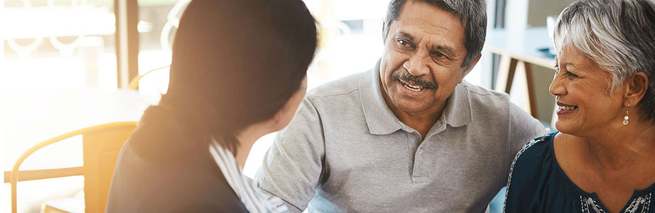 senior couple having coffee with a business woman