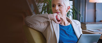 business woman sitting on a chair thinking