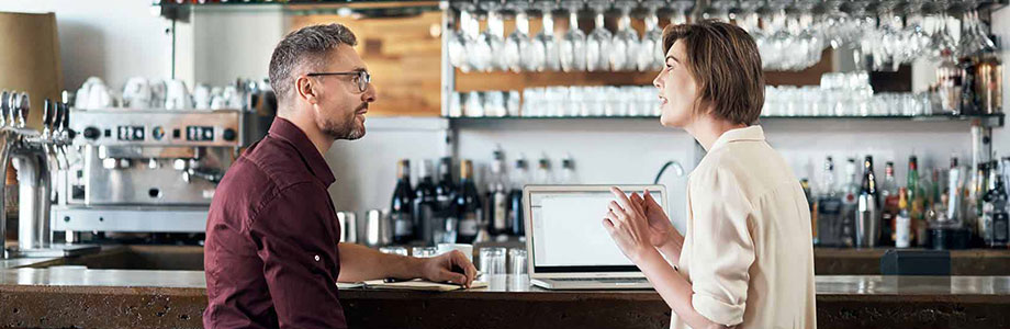 male and female talking at a restaurant counter