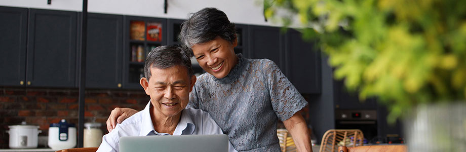 senior couple looking at a laptop