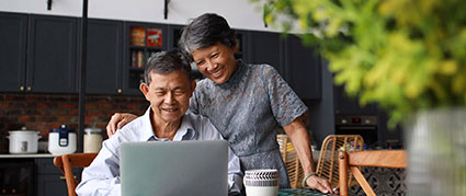 senior couple looking at a laptop