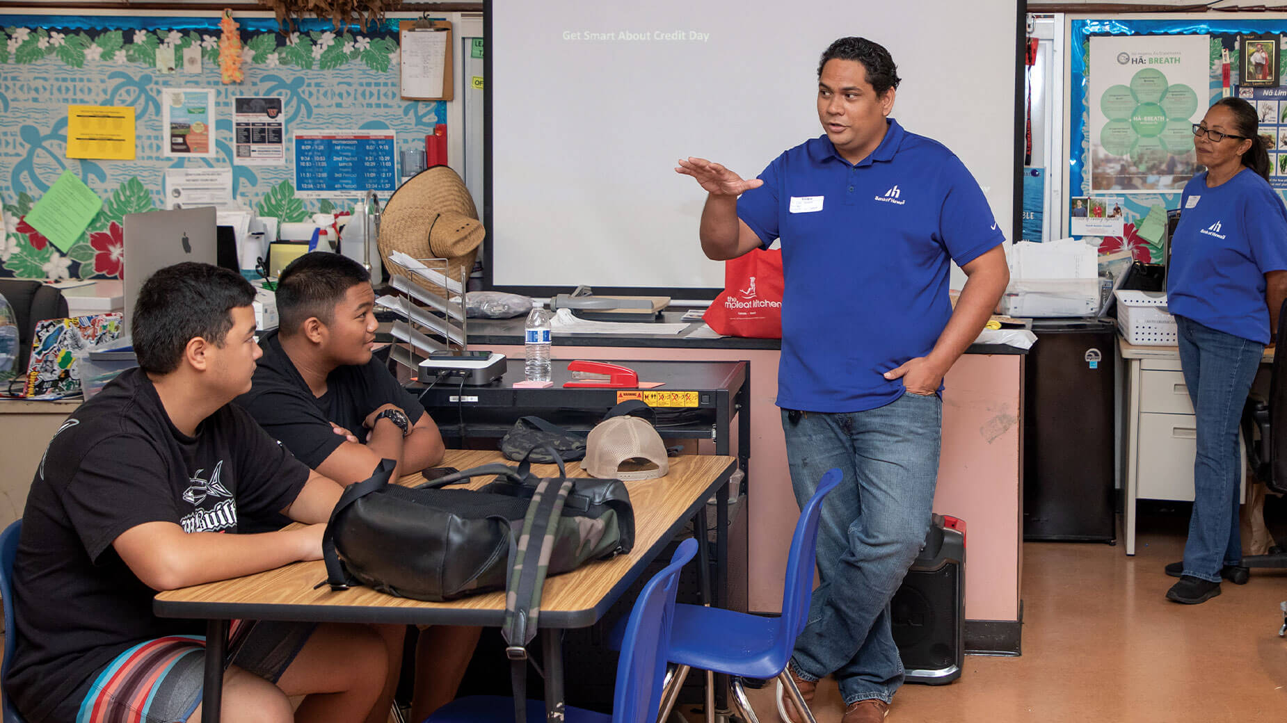Employee teaching financial literacy at Waianae High School
