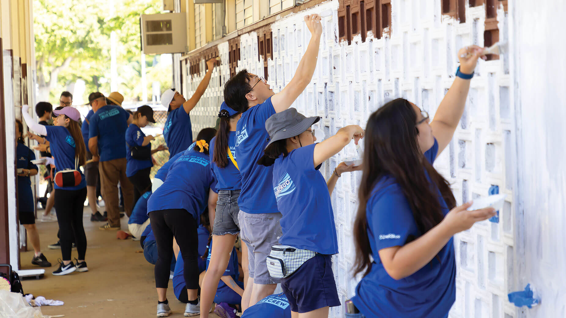 employees painting school at Community Service Day