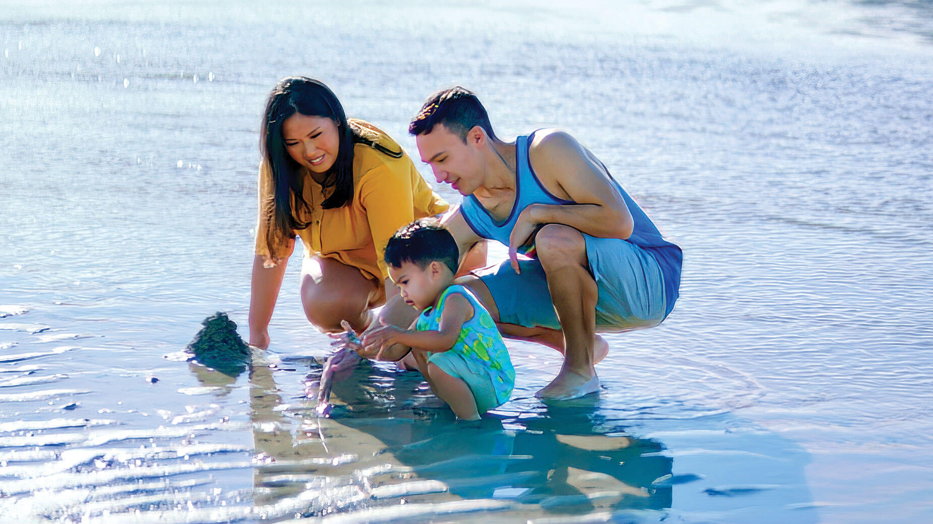 Matt Pollard playing with his family at the beach