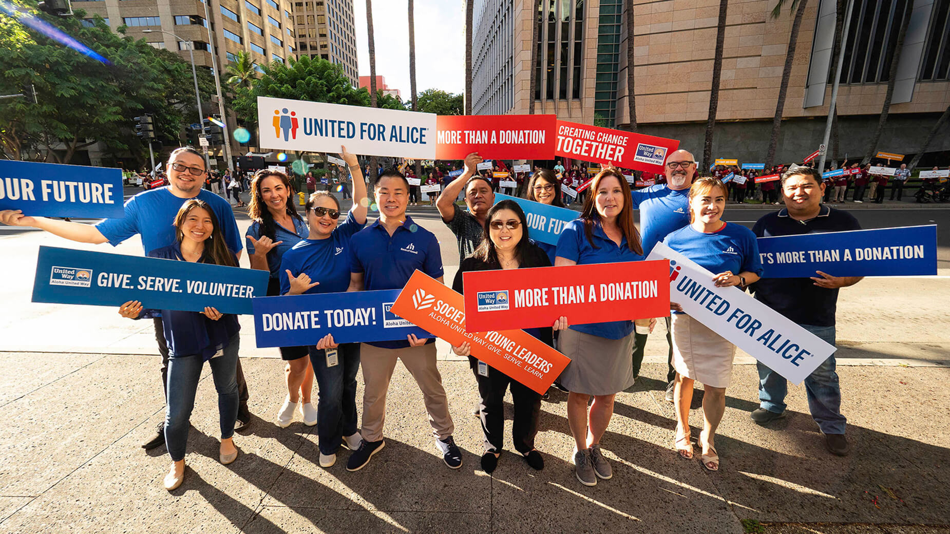 employees at Aloha United Way sign waving