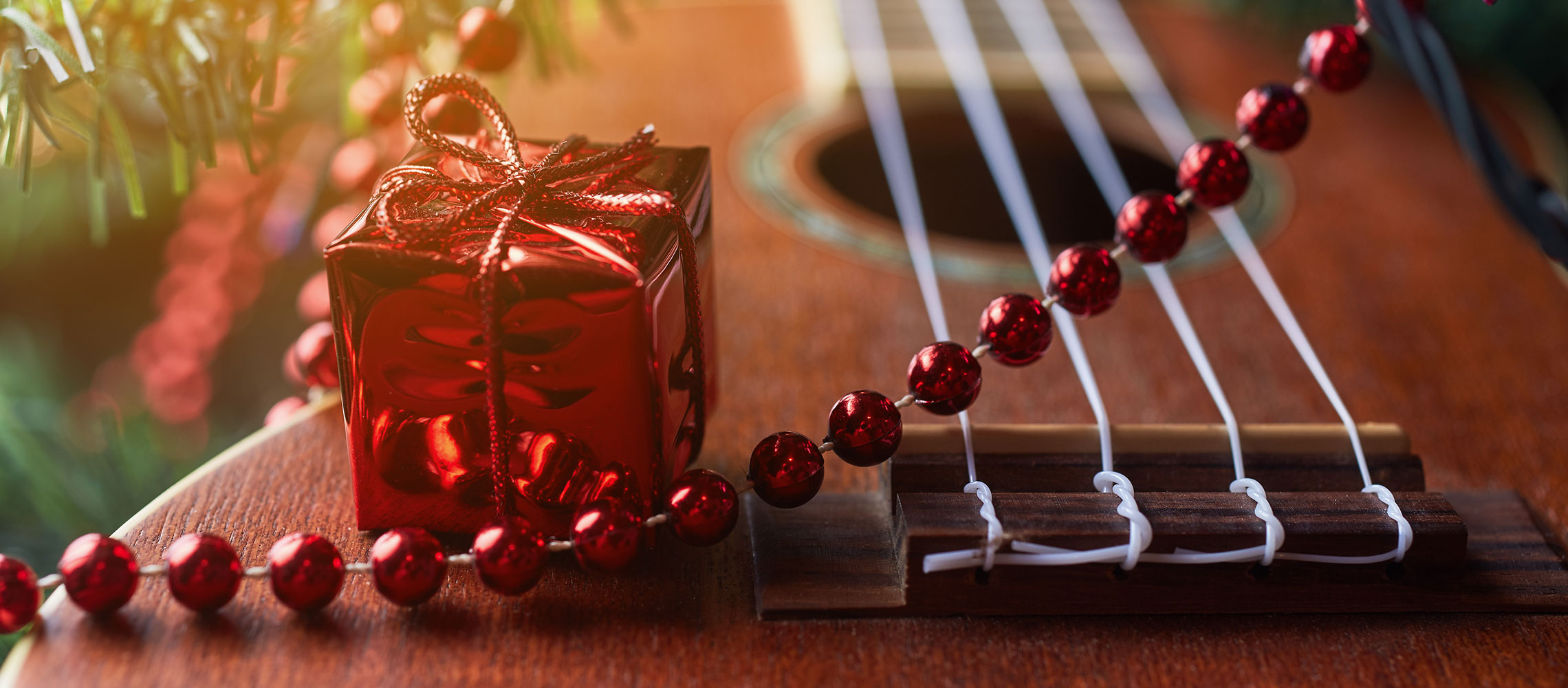 closeup of small present and ukulele - How to Prepare for Holiday Rush