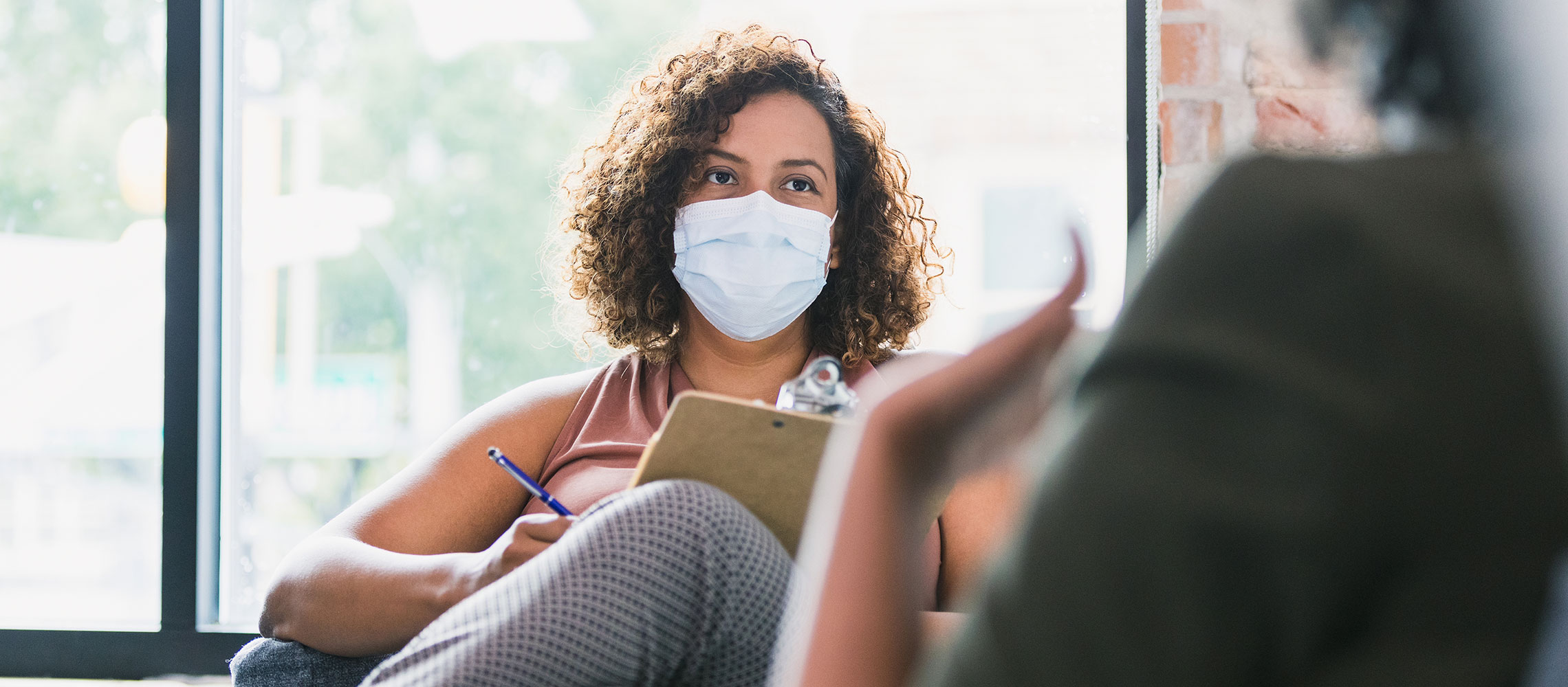 female credit counselor in mask