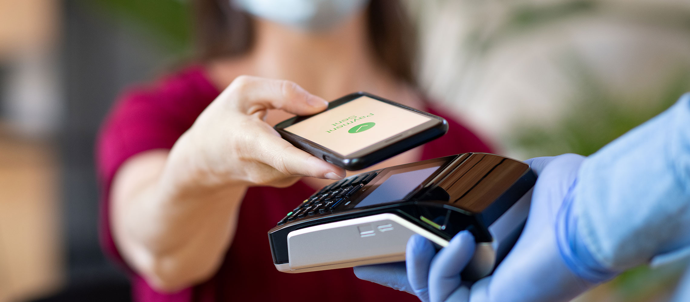 woman paying with smartphone