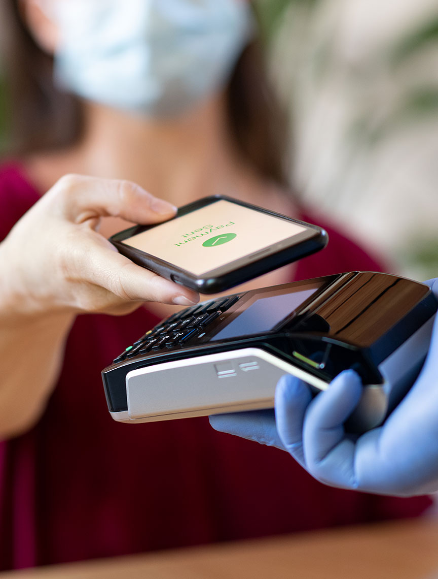 woman paying with smartphone