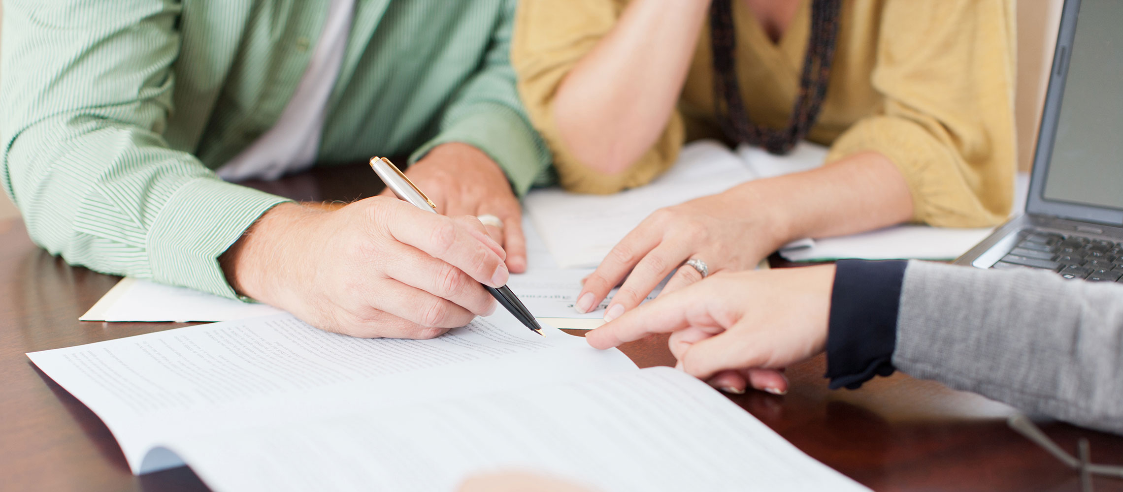 closeup of couple signing mortgage application