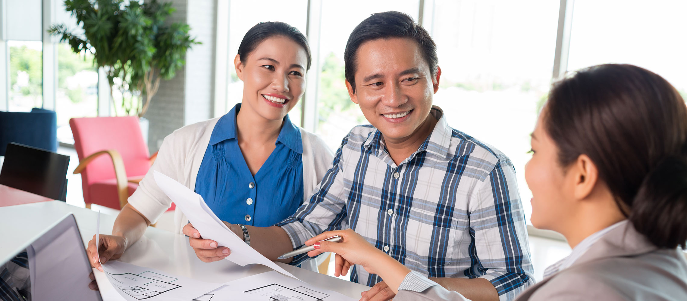 Couple consulting with banker on mortgage