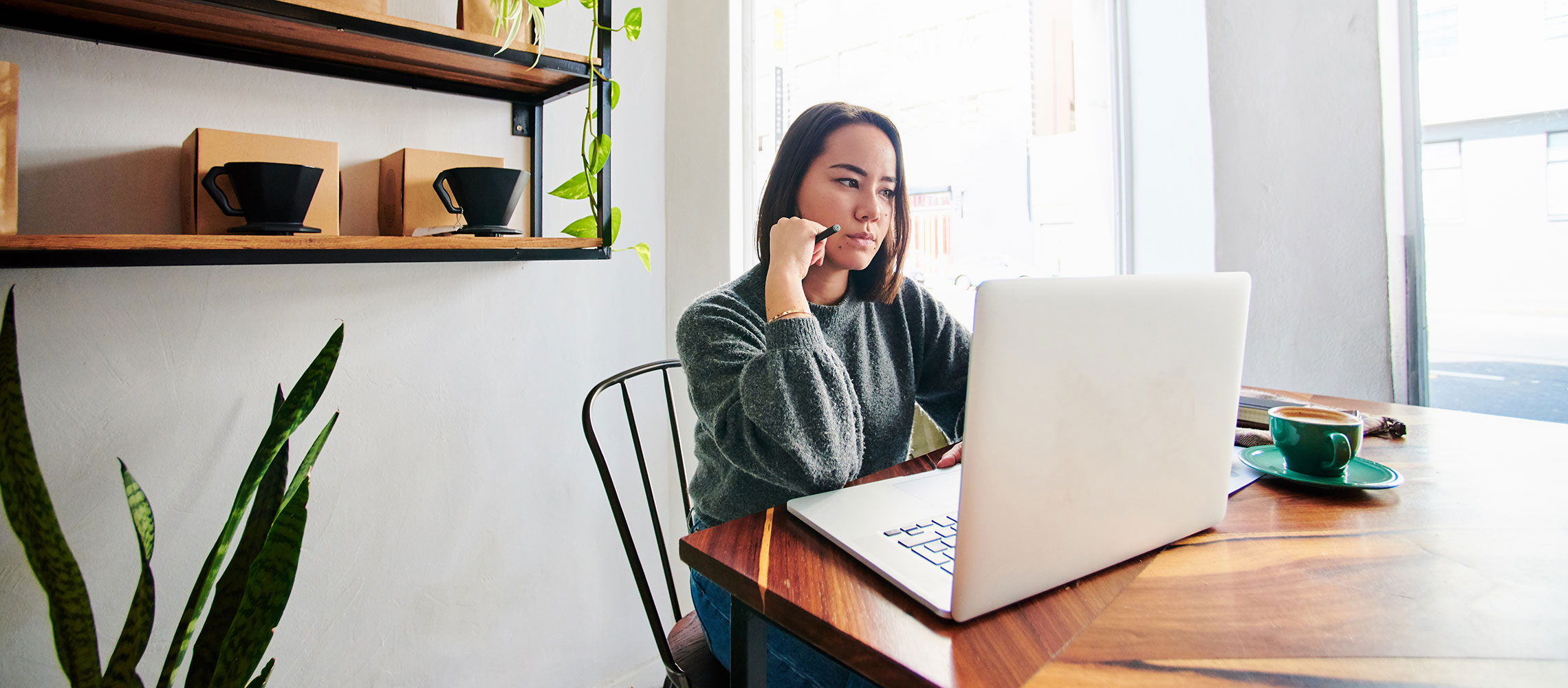 woman working at laptop, watch out for work-from-home scams