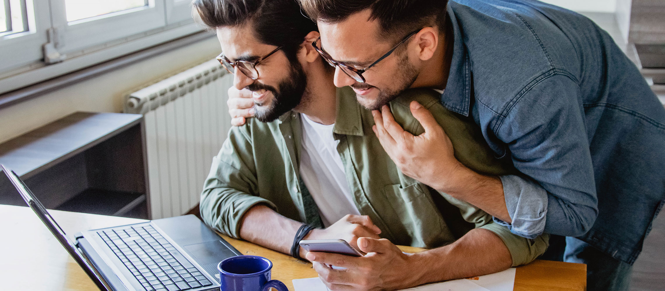 couple hugging while discussing finances