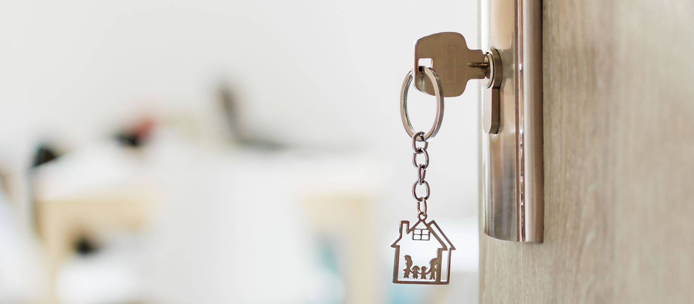 closeup of key in home door - buy or sell