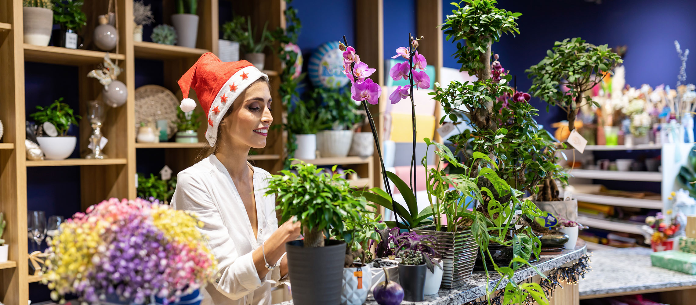 Business owner arranging flowers for the holidays