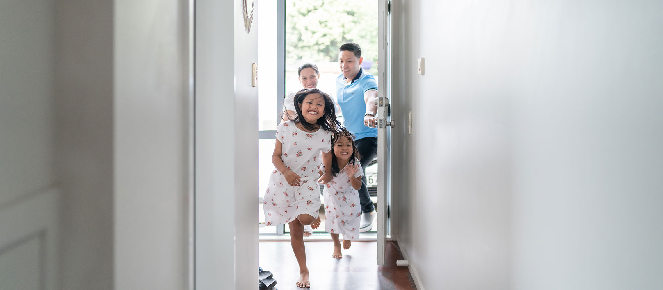 family entering house after paying down payment