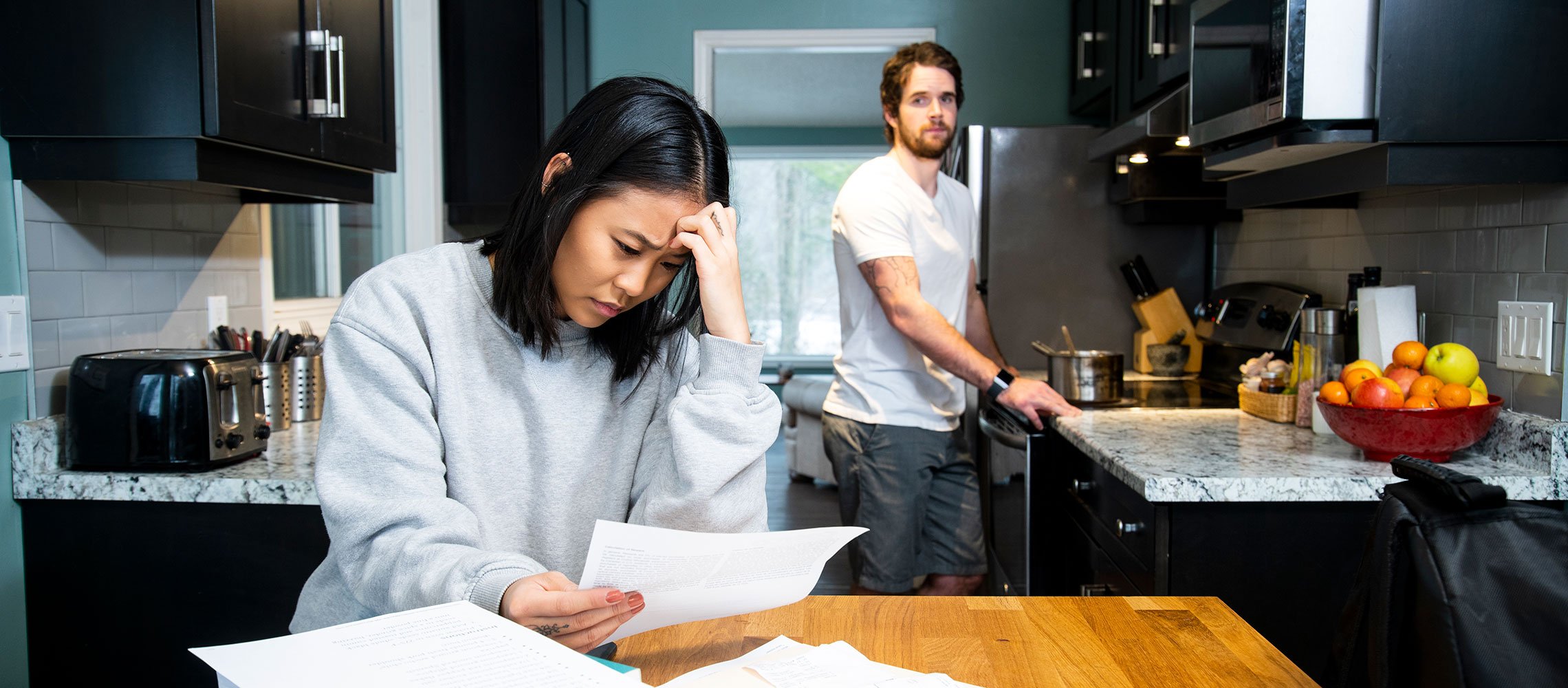 couple in kitchen worried about not being able to pay rent