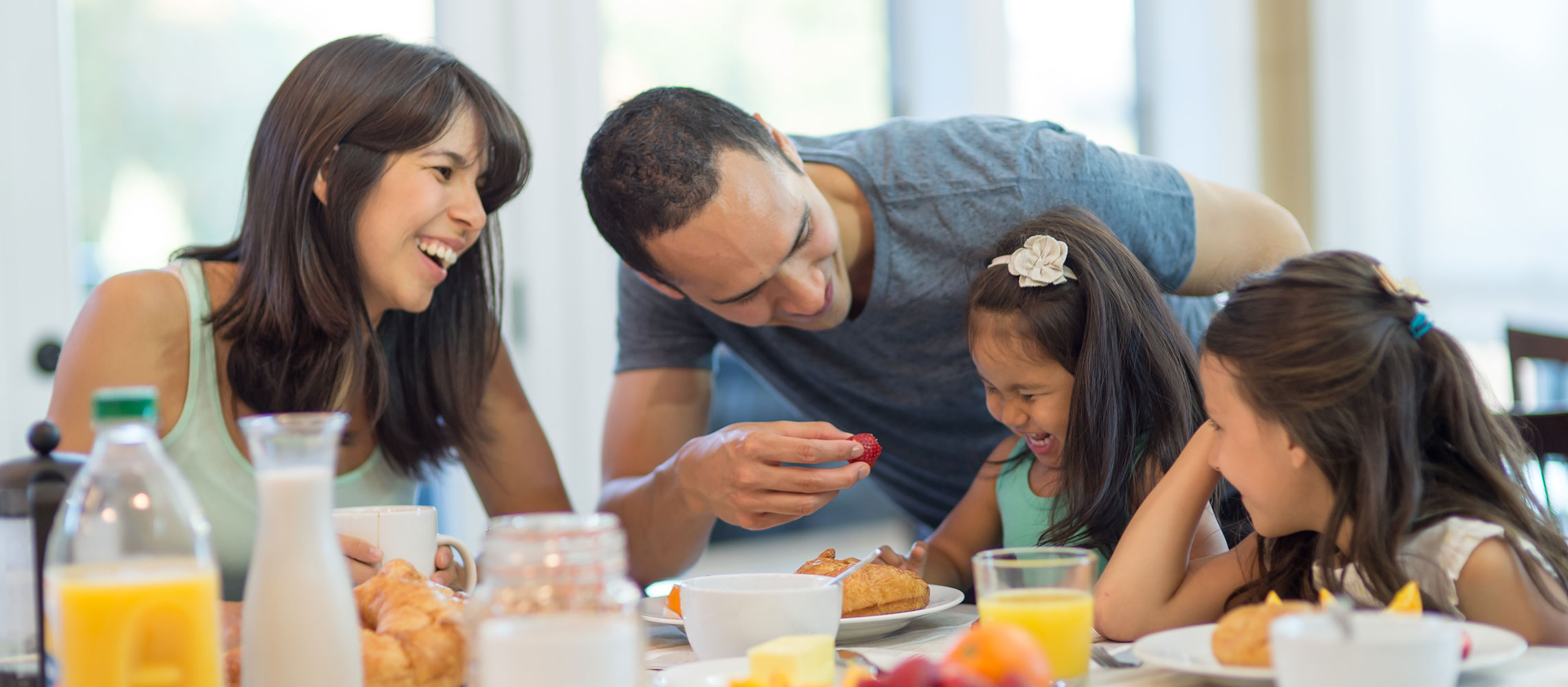 family of four eating breakfast