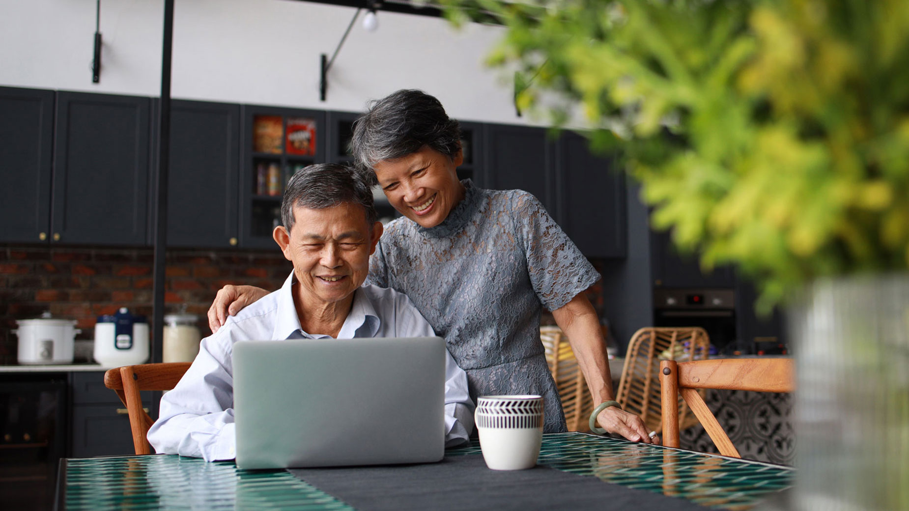 senior couple looking at a laptop