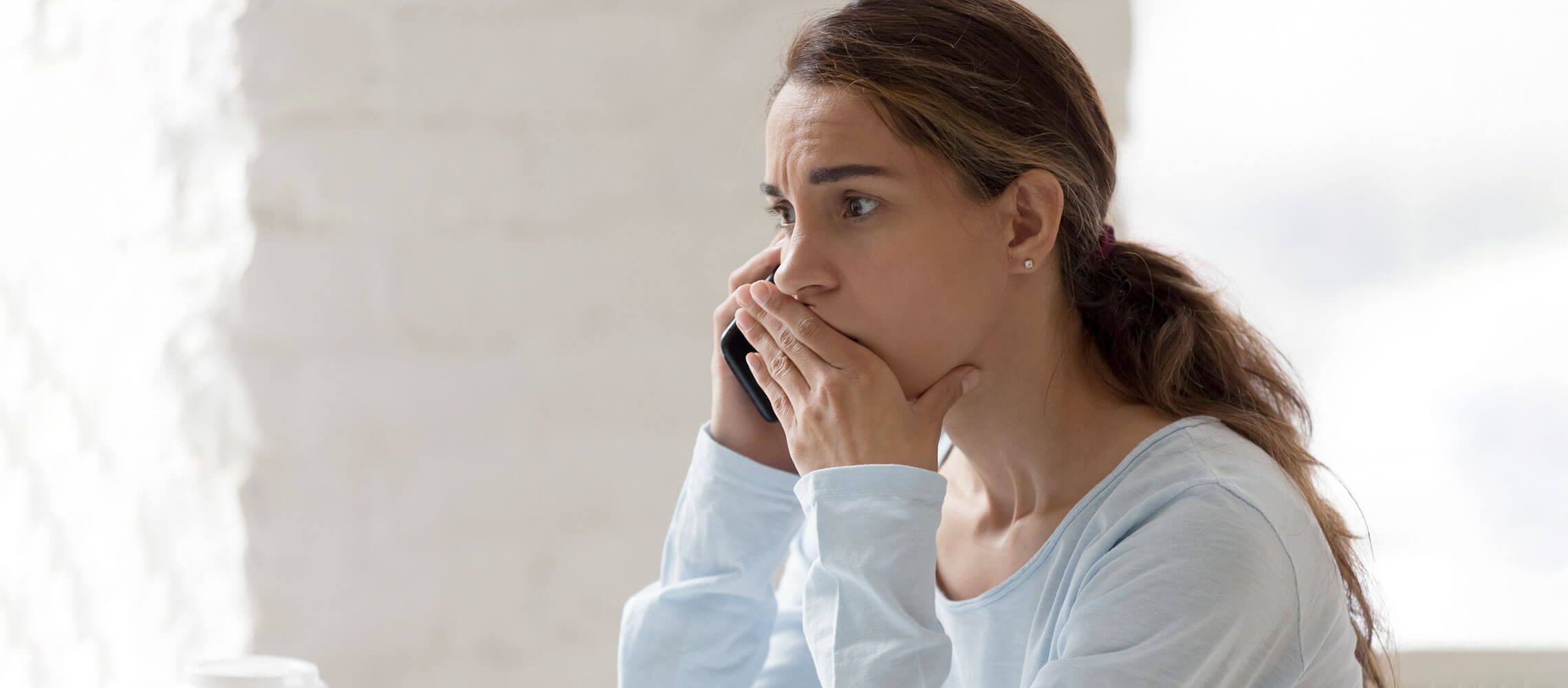 worried woman speaking on phone