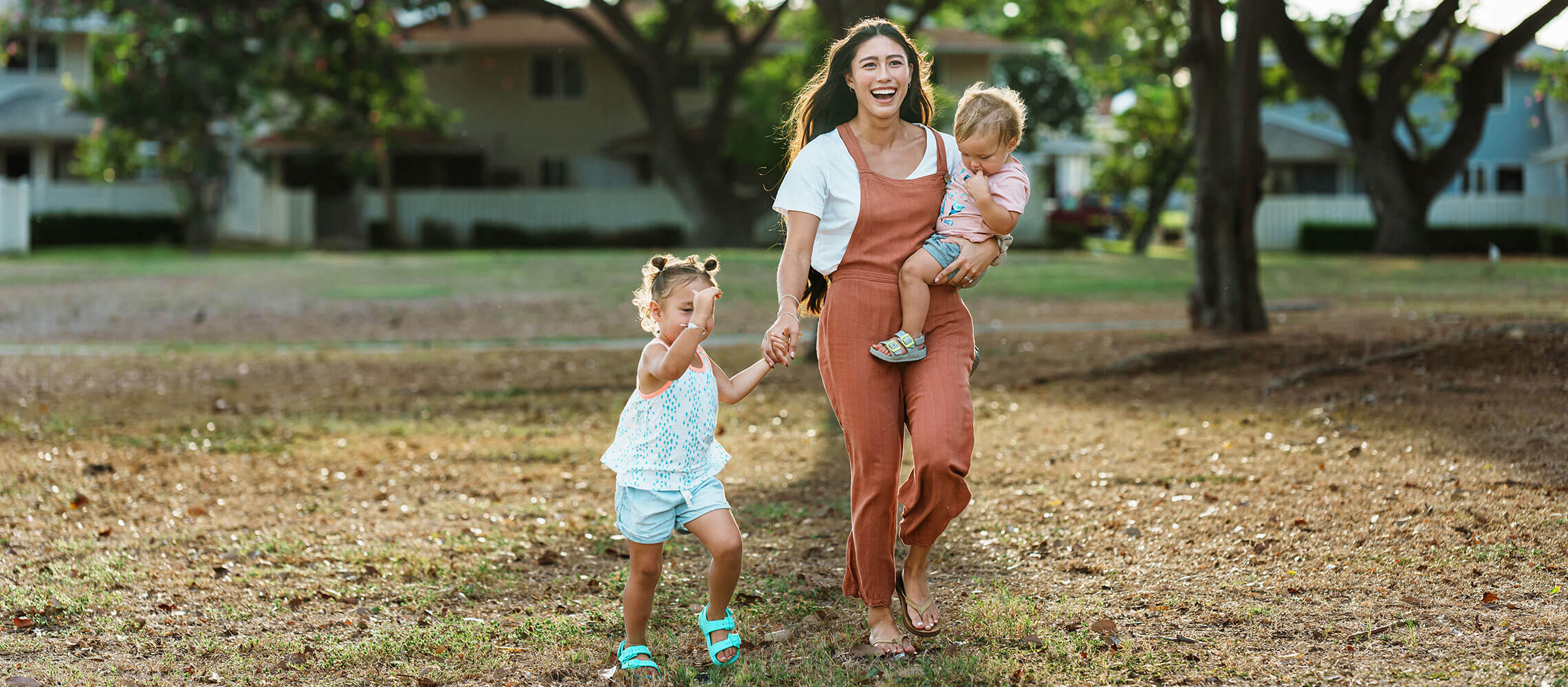 mom and children walking in a park