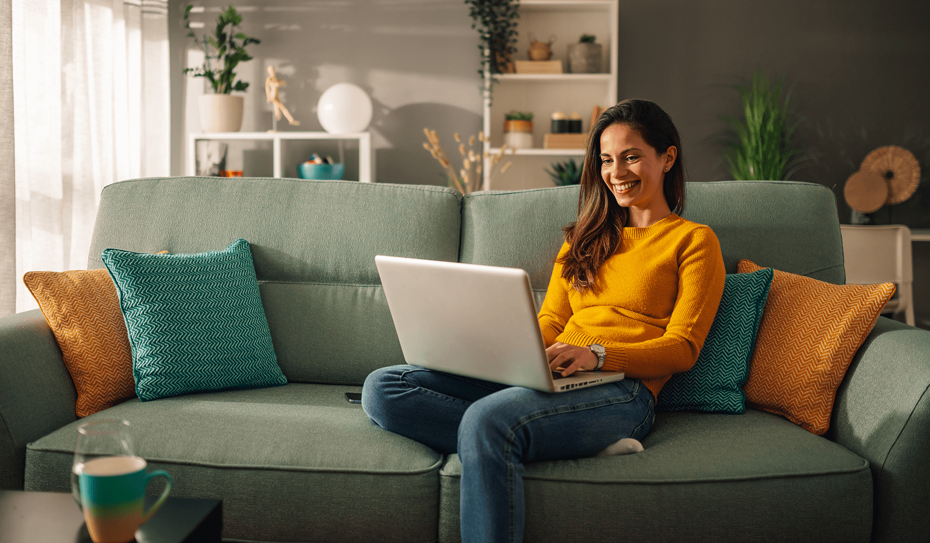 woman sitting on couch with laptop
