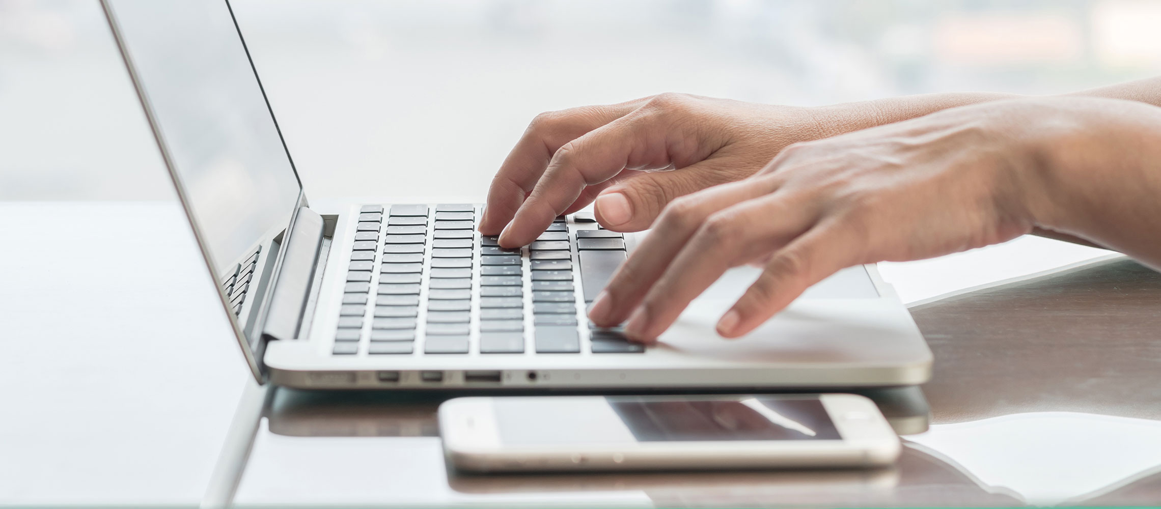 person typing on a laptop