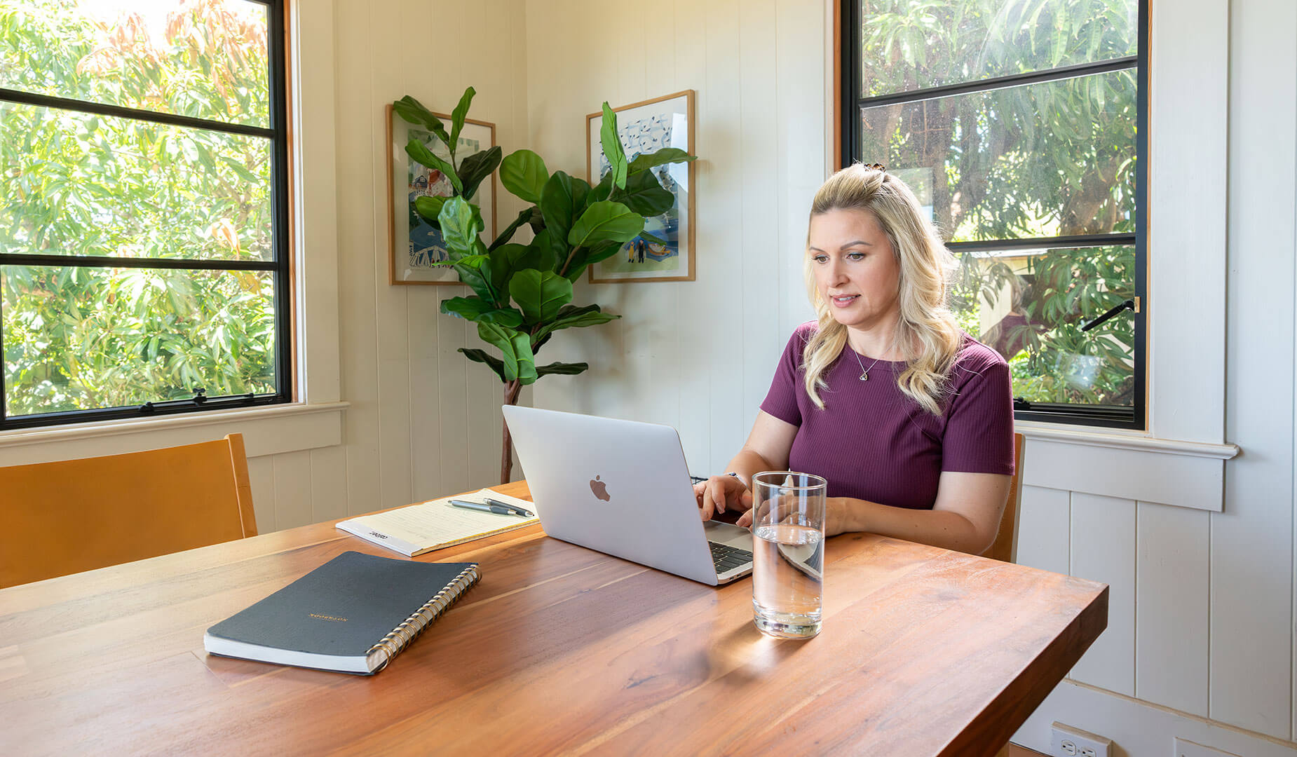 rita sitting in her kitchen with a laptop