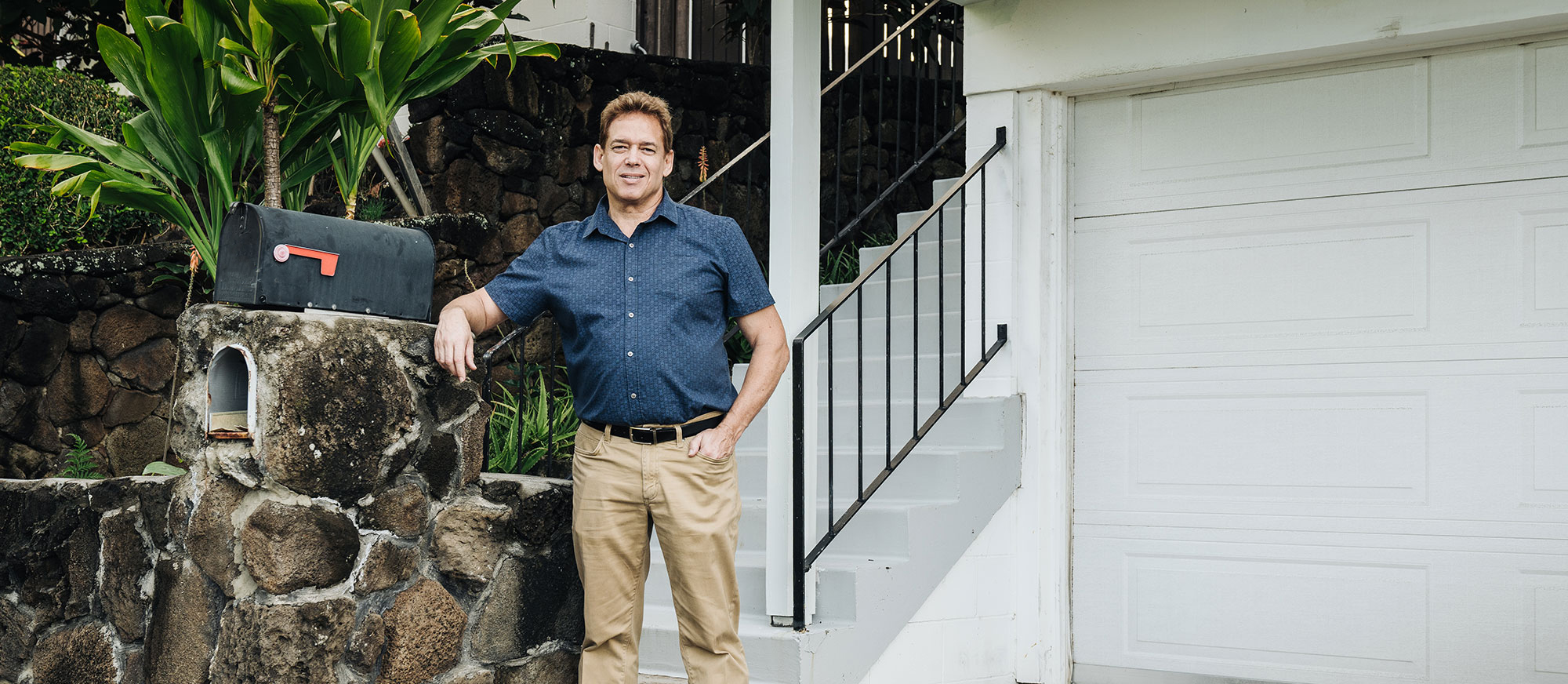 man in front of house