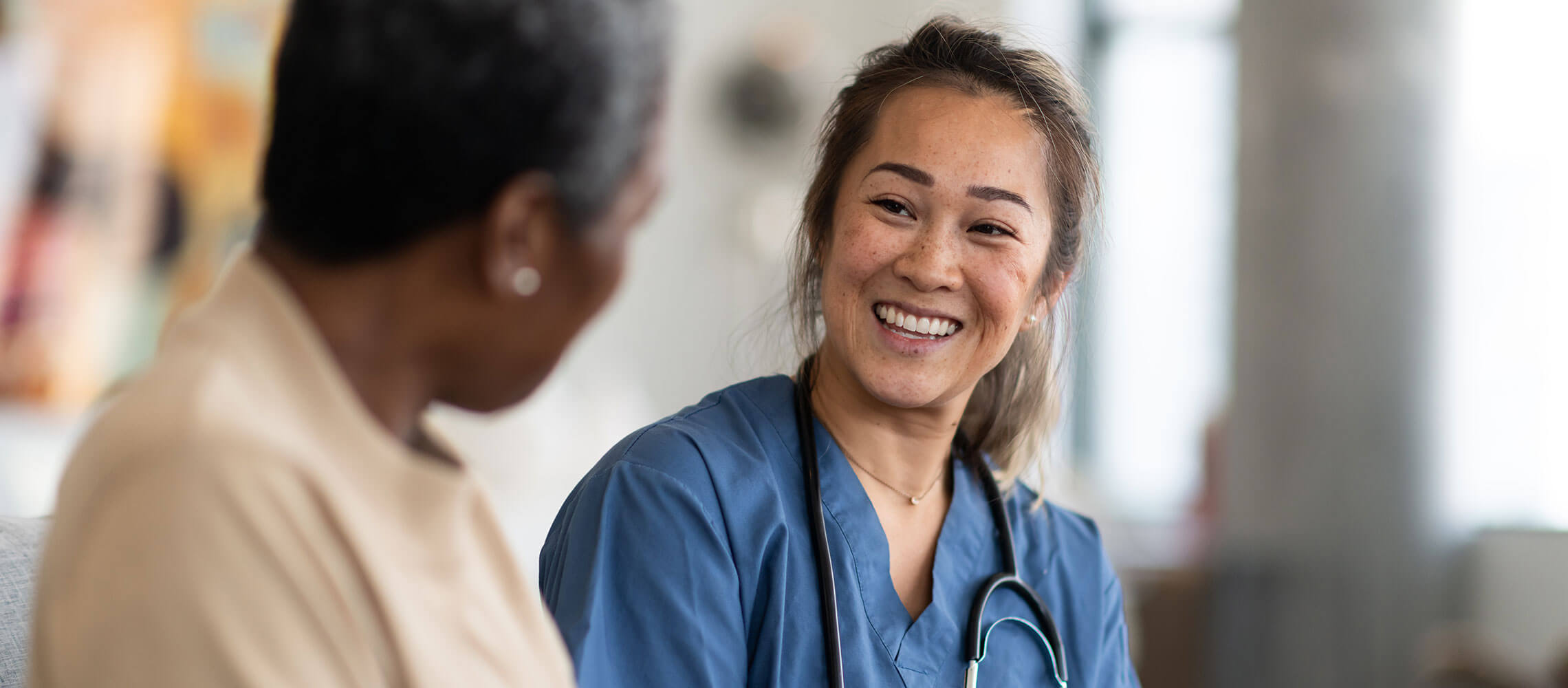 friendly nurse speaking with patient