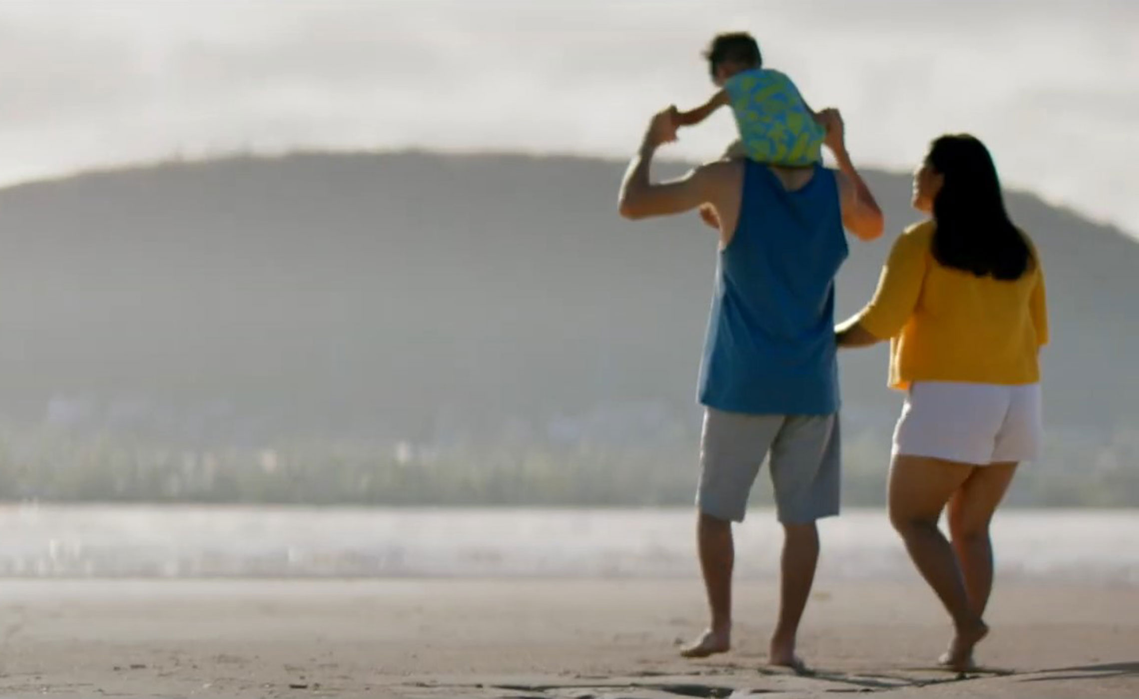 Matt Pollard and family walking on beach