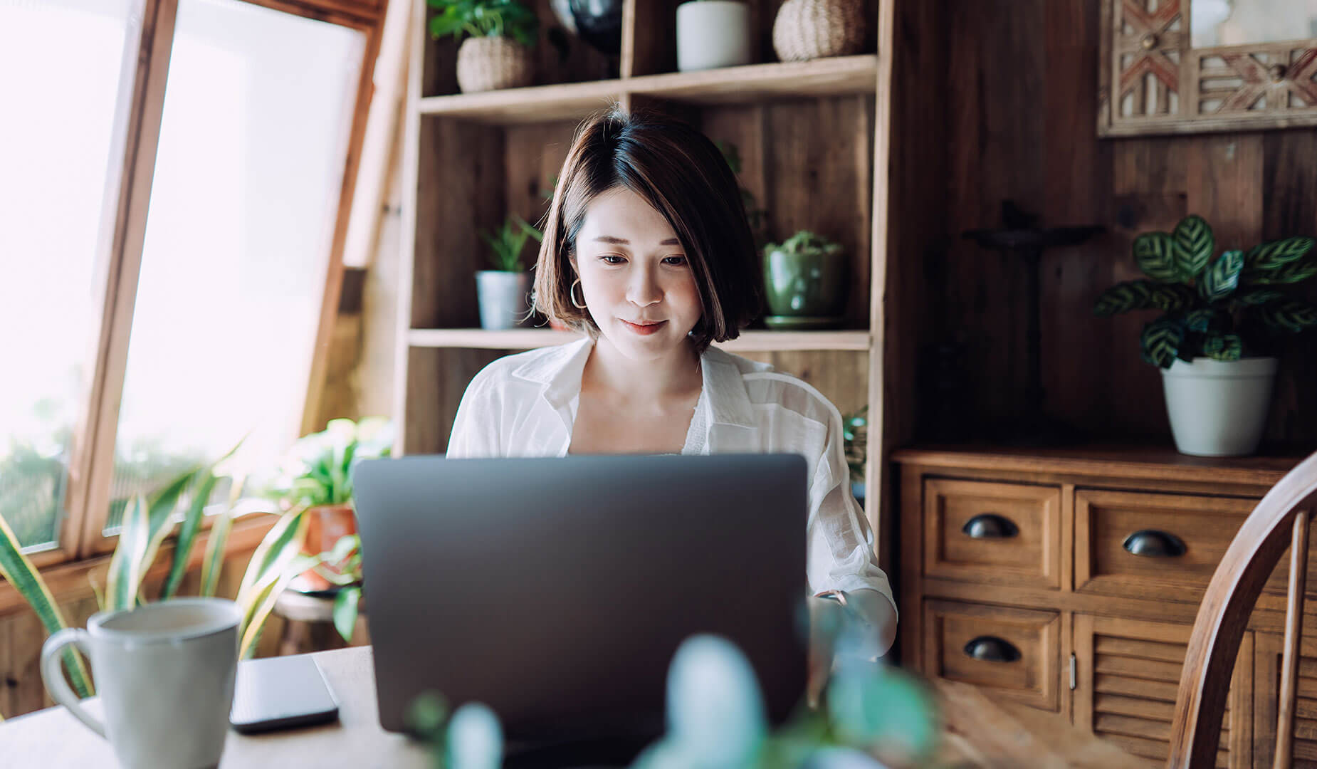 woman working on her laptop in her living room