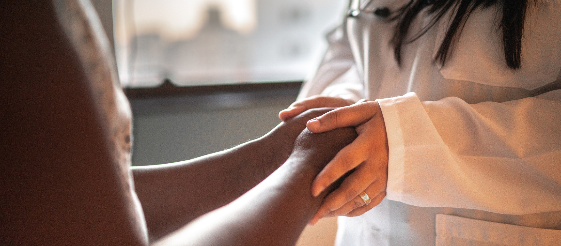 Doctor holding patient's hands