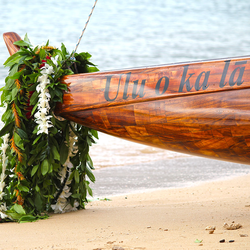 Ulu o ka Lā canoe with lei