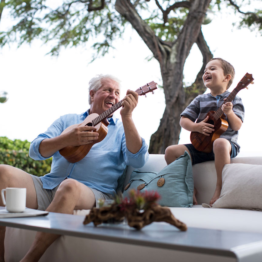 grandpa and child playing the ukulele