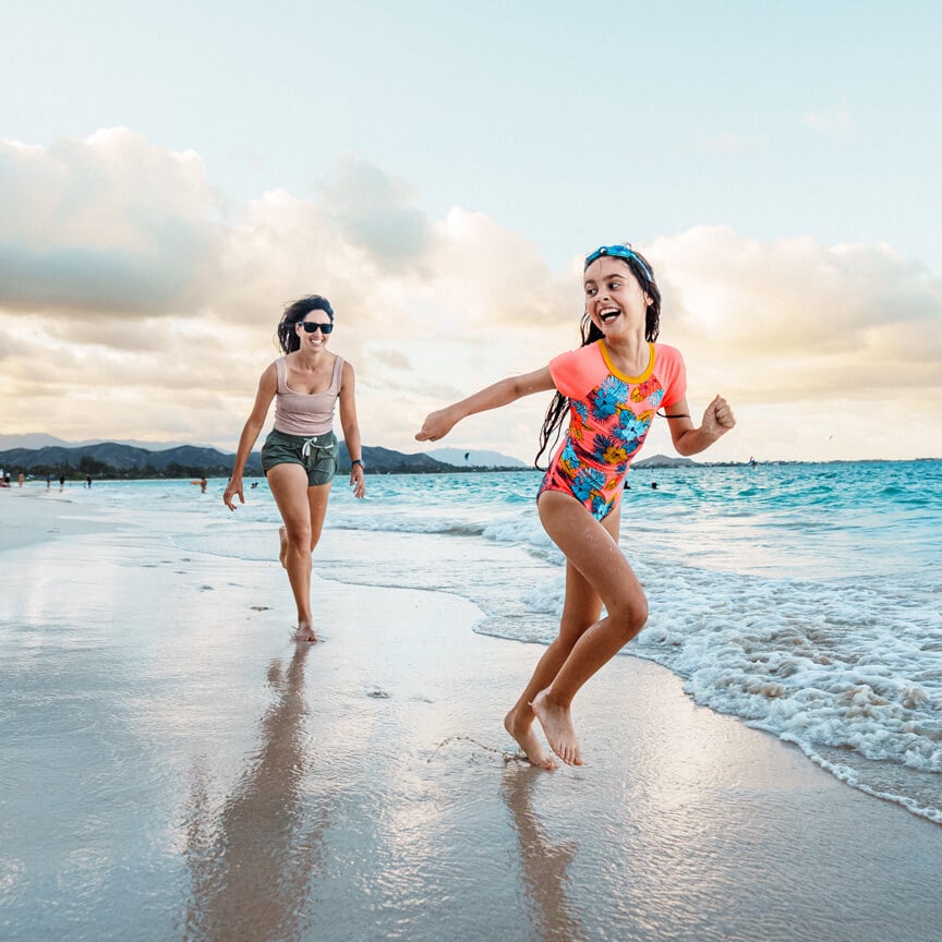 two young girls playing on the beach