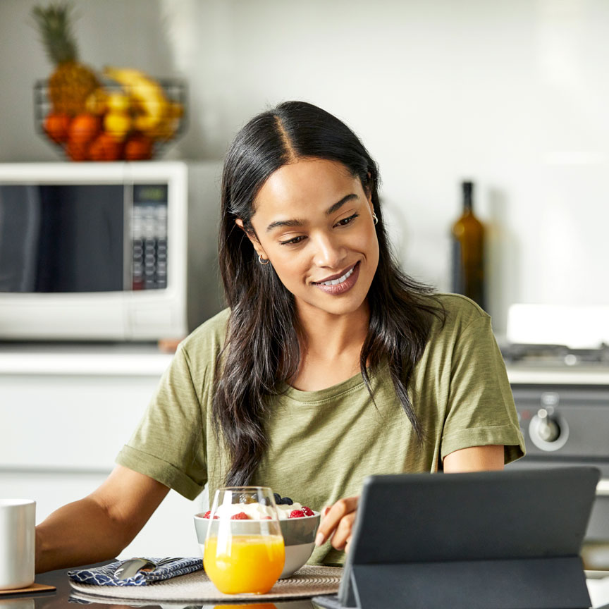 woman looking at tablet in kitchen