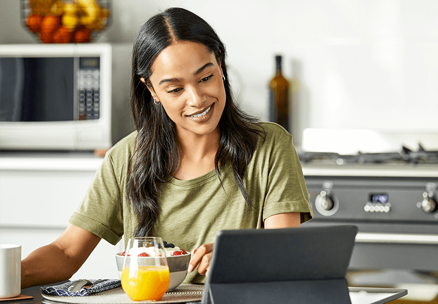 woman looking at tablet in kitchen
