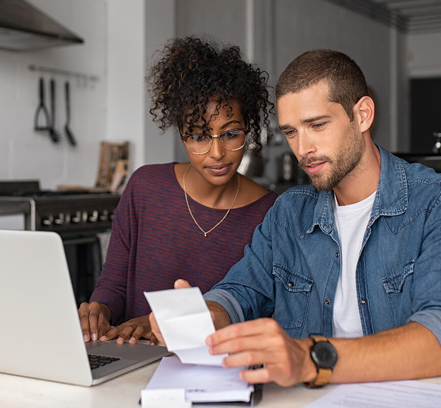 couple calculating finances with laptop