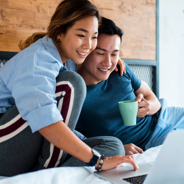 A young couple completing an online application to prequalify for a home purchase.