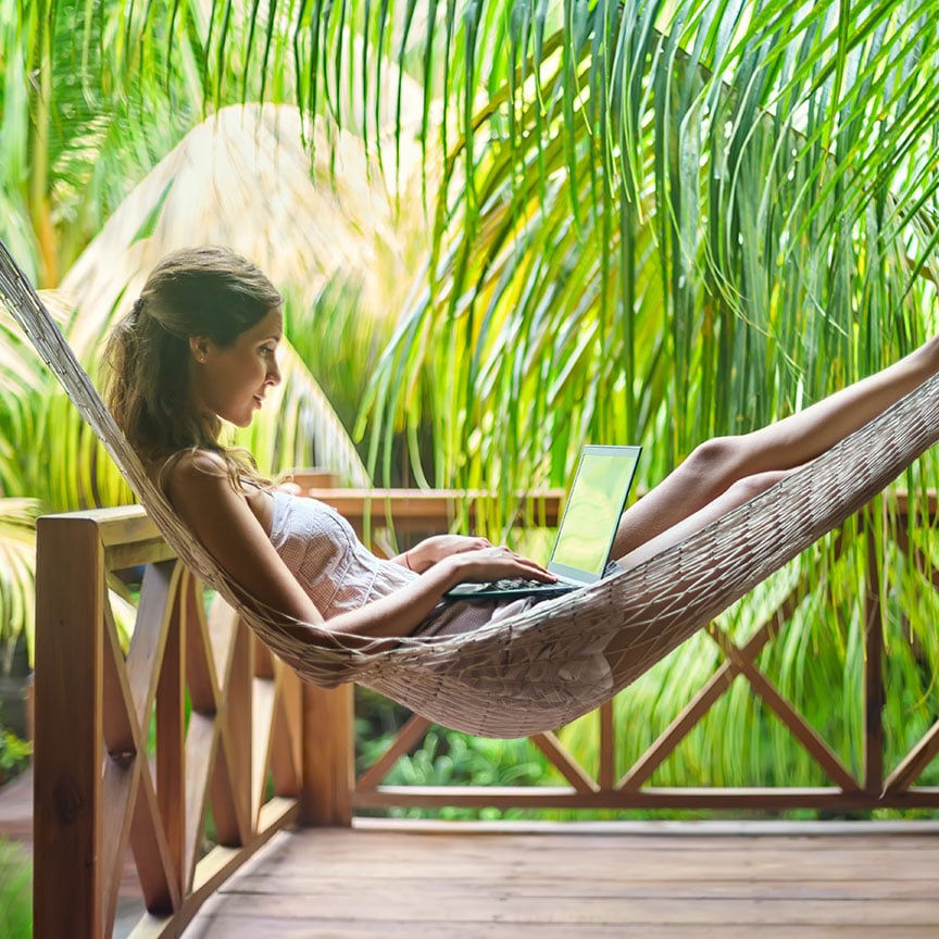 woman with laptop in a hammock