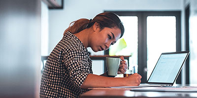 woman writing on notepad