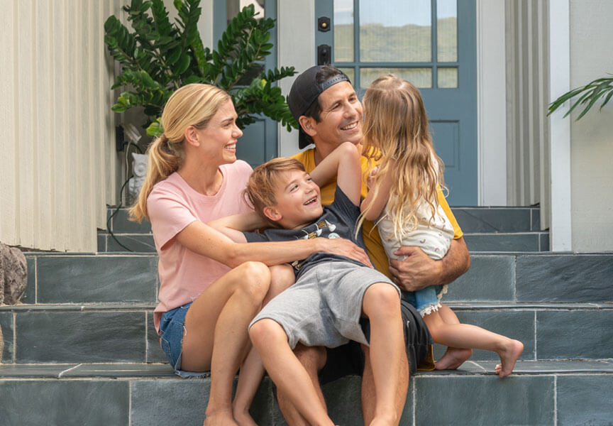 family sitting on the front steps